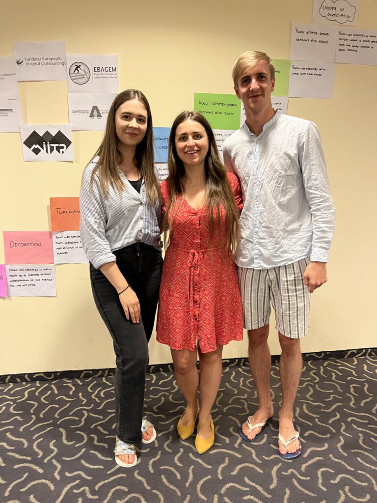 3 young persons in seminar room