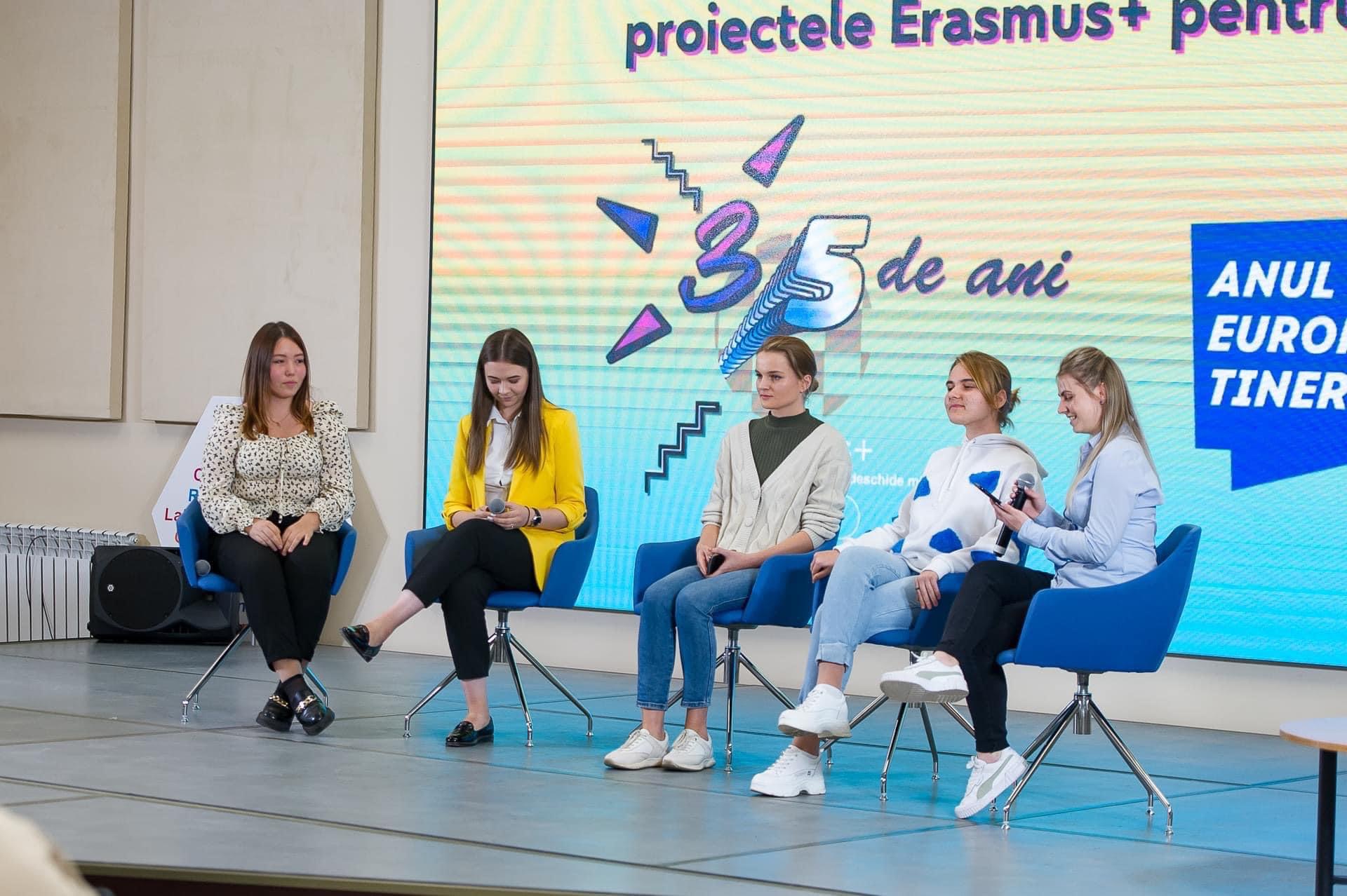 A group of women sitting on a stage