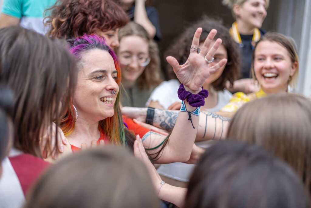 A crowd of young peole and one gesticulating