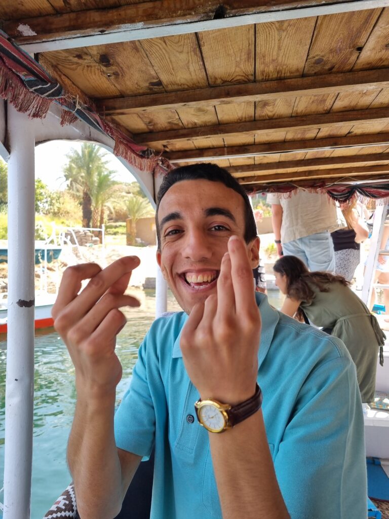 youth Egyptian man smiling and snapping fingers