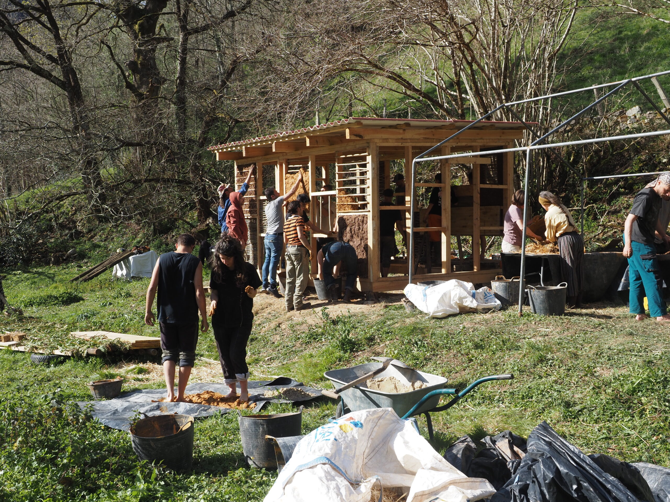 A wooden construction in the nature, young people working
