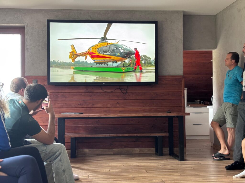 group watching a helicopter on a screen